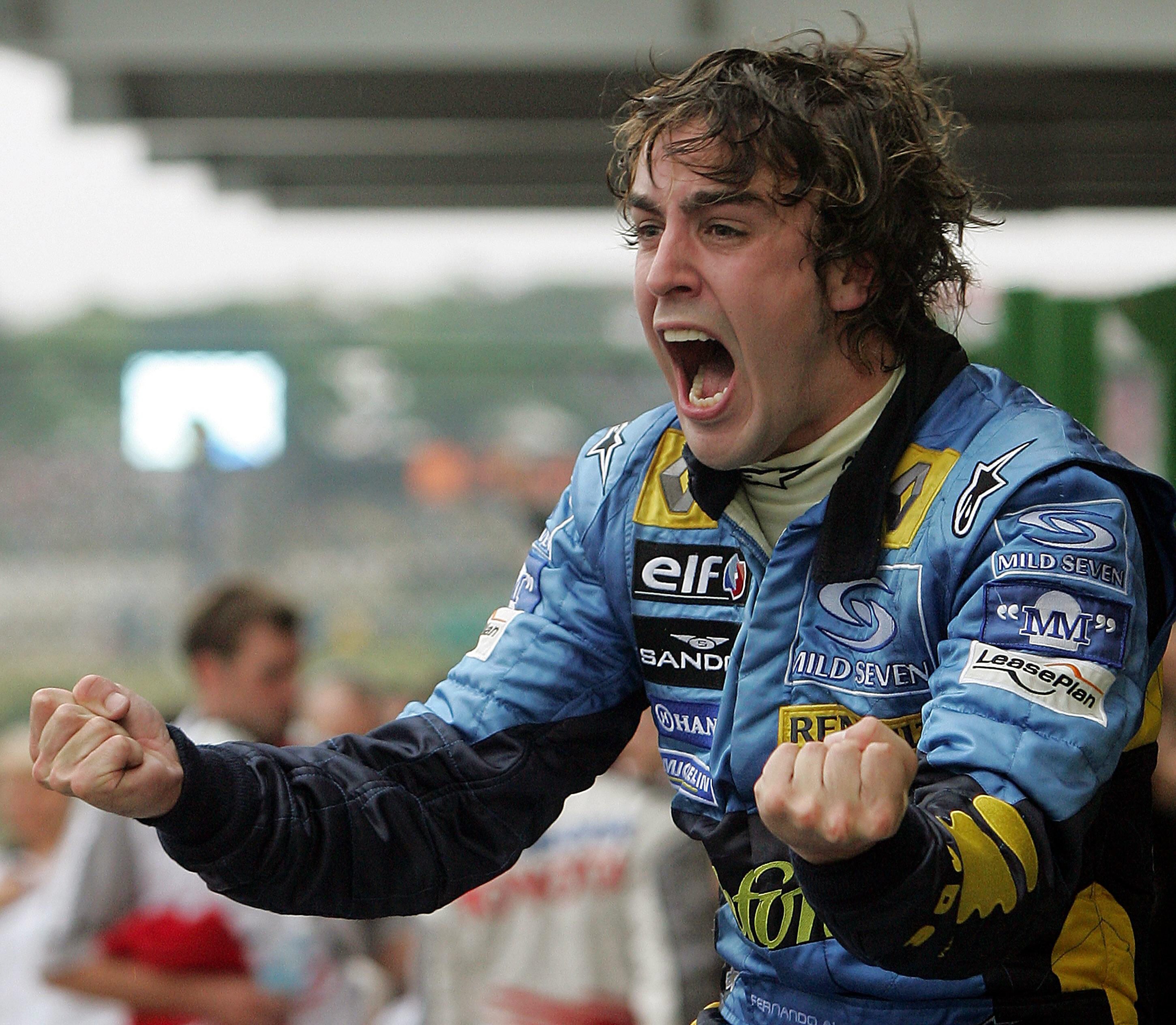 Spanish Formula One driver Fernando Alonso of Renault celebrates his World Champion title after arriving third in the Brazilian F1 GP, 25 September, 2005 at the Interlagos racetrack in Sao Paulo, Brazil. AFP PHOTO ANTONIO SCORZA