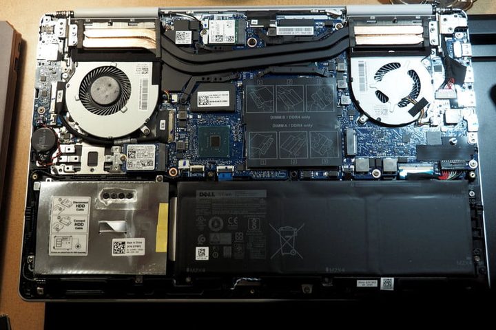 Vista del interior de una Dell Inspiron 15 7000, donde se observan los disipadores del procesador principal y de video, la bateria, eldisco duro y la tarjeta principal
