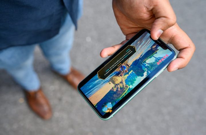 una persona sujeta un iPhone 11 con la mano