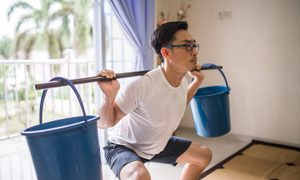 aparatos de gym para casa an asia chinese man doing squat workout by using bucket instead of weights equipment training at ho