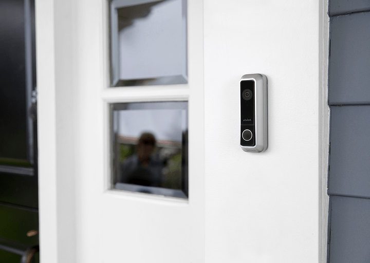 Timbre de video montado en la pared de una casa para comparar Vivint vs. Ring