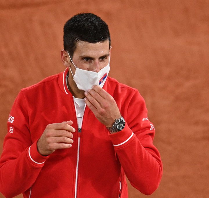 La imagen muestra al tenista serbio Novak Djokovic usando una mascarilla.