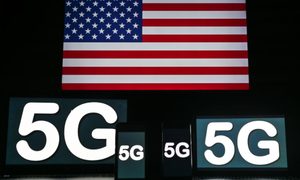 La imagen muestra la bandera de Estados Unidos y varios dispositivos mostrando "5G" en sus pantallas.