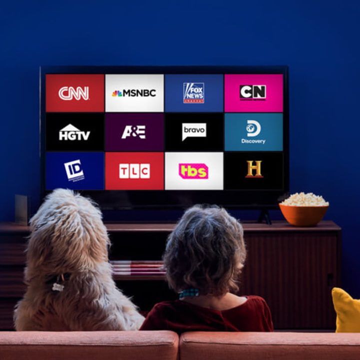 Una familia mira el televisor donde aparecen los canales disponibles en Sling TV.