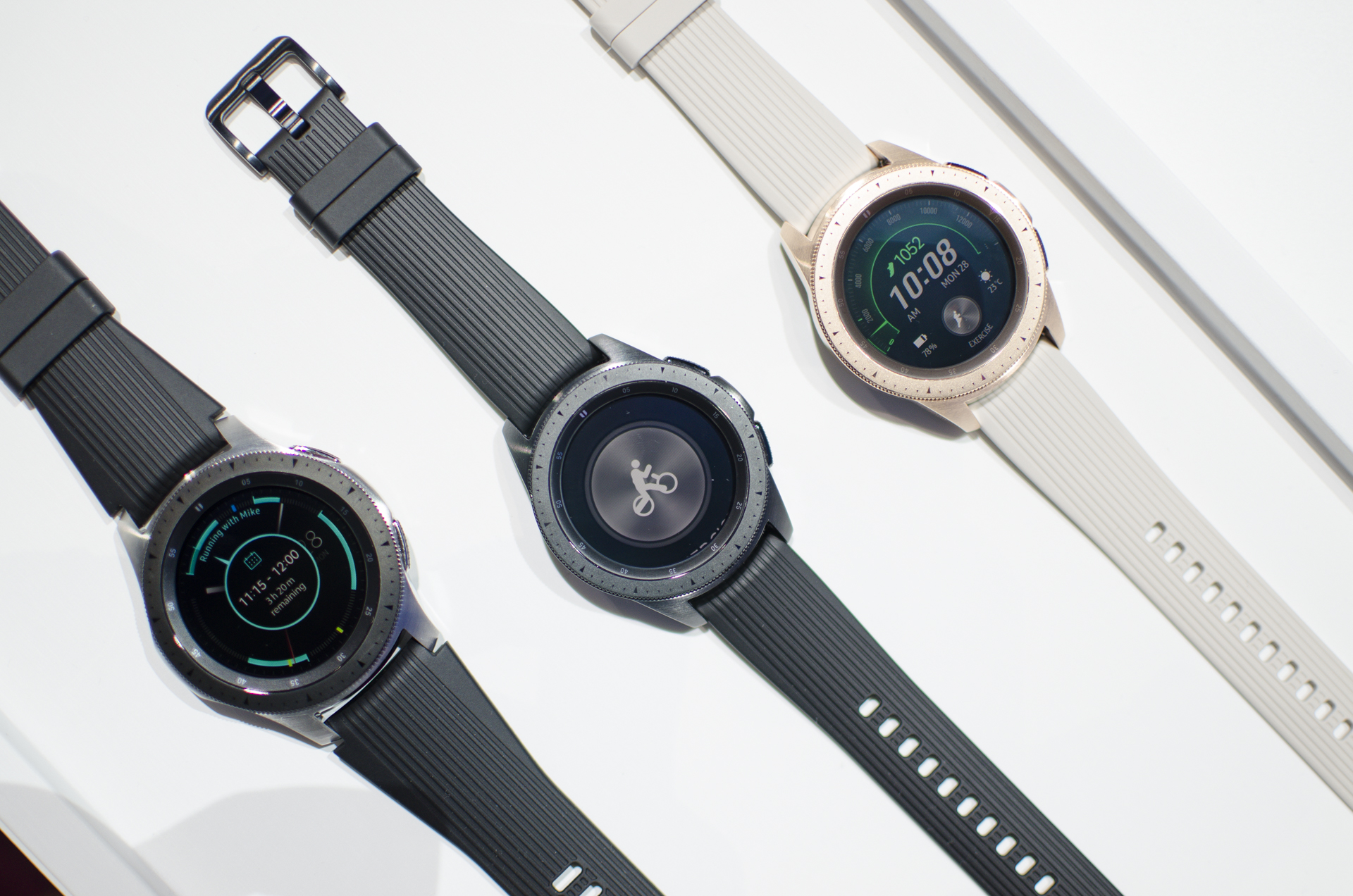 Tres modelos de distintos colores del Galaxy Watch estirados sobre una mesa.