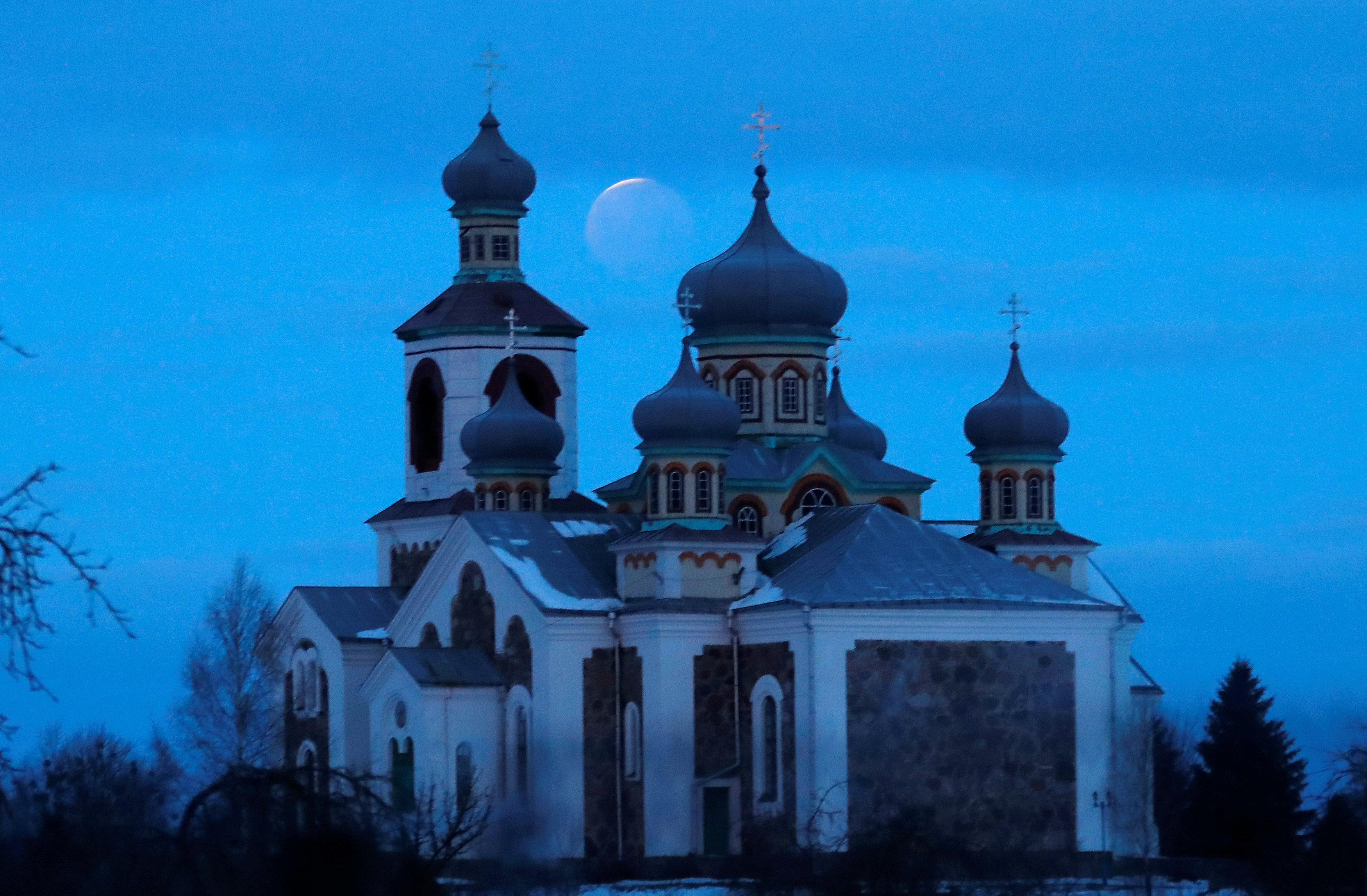 eclipse lunar super luna the  blood wolf moon is seen behind an orthodox church during a in village of turets
