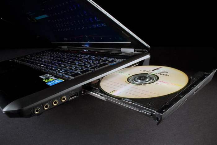 Un lector de CD de una computadora abierto con un discos en su interior | Cómo grabar un CD