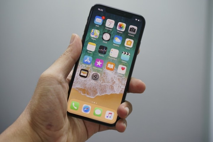 Man holding iPhone X to find out what to do with iPhone