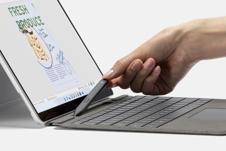 Surface Pro 8. Mano levantando el Slim Pen 2.