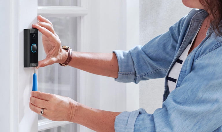 Una mujer cambiando la batería de un Ring Video Doorbell.