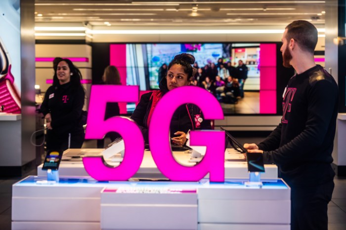 oneplus 10 pro vs iphone 13 customers at a t mobile store  with 5g signage
