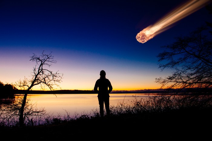 bola de fuego texas silhouette of adult watching meteor falling in night sky