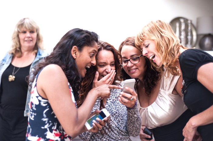 ocultar fotos y videos telefono android women looking at the smartphone photos they took