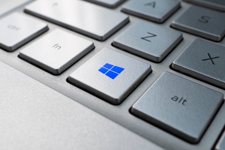 Teclado de computadora con el logo de Windows en azul sobre una tecla – Windows 11 vs. Windows 10: ¿deberías actualizarte?