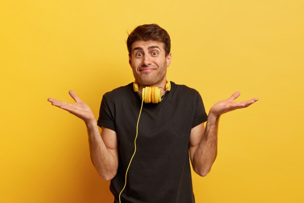 Un hombre confundido usando audífonos.