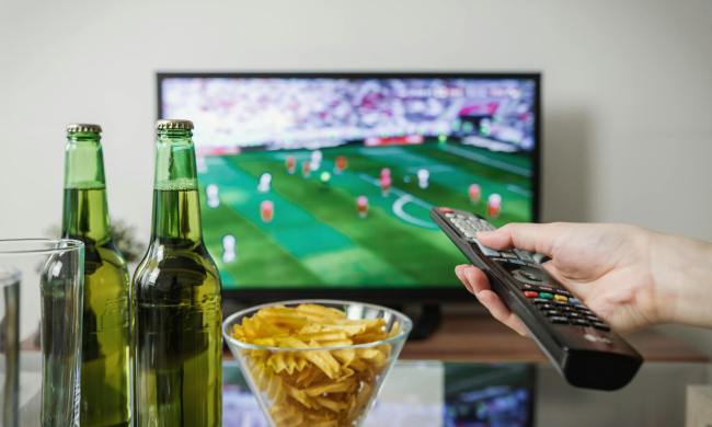 Un televisor con fútbol y comida.
